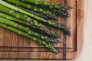fresh asparagus on a cutting board